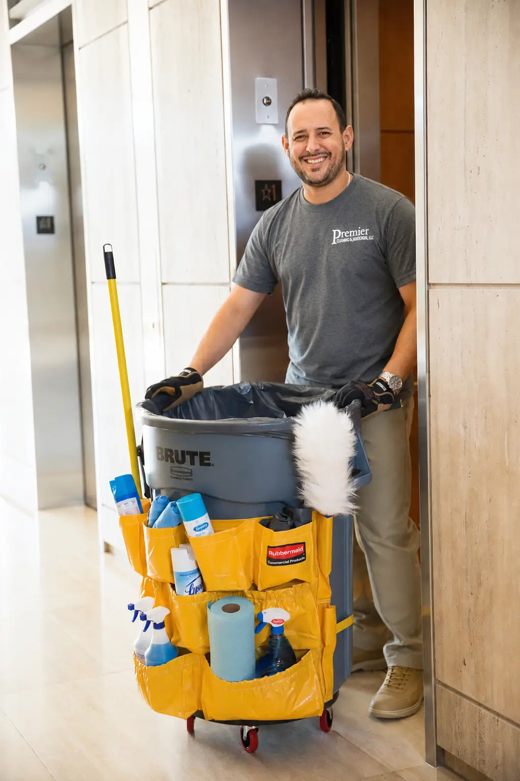 premier cleaning janitor walking with a janitorial trash can lined with janitorial cleaning supplies