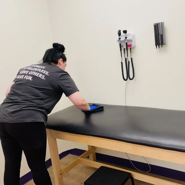 Premier Cleaning & Janitorial Medical Facility Cleaning Services - sanitizing a medical exam room bed