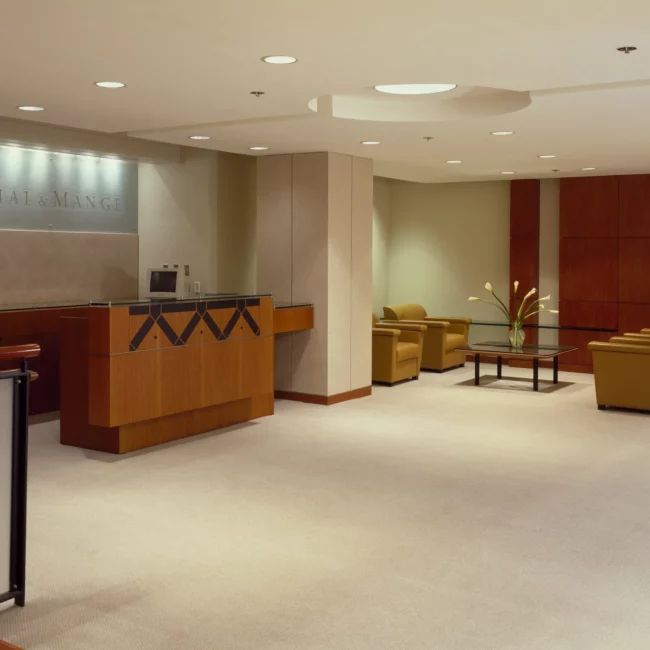 Office reception lobby with a front desk and lounge chairs