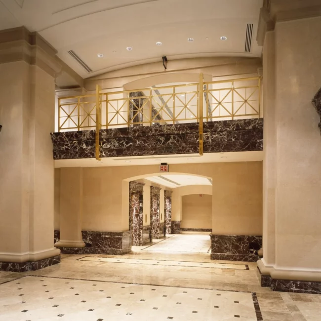 Office lobby with marble columns and a polished stone floor