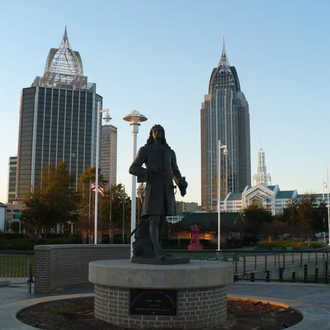 Downtown Mobile, Alabama skyline behind a statue in a city park