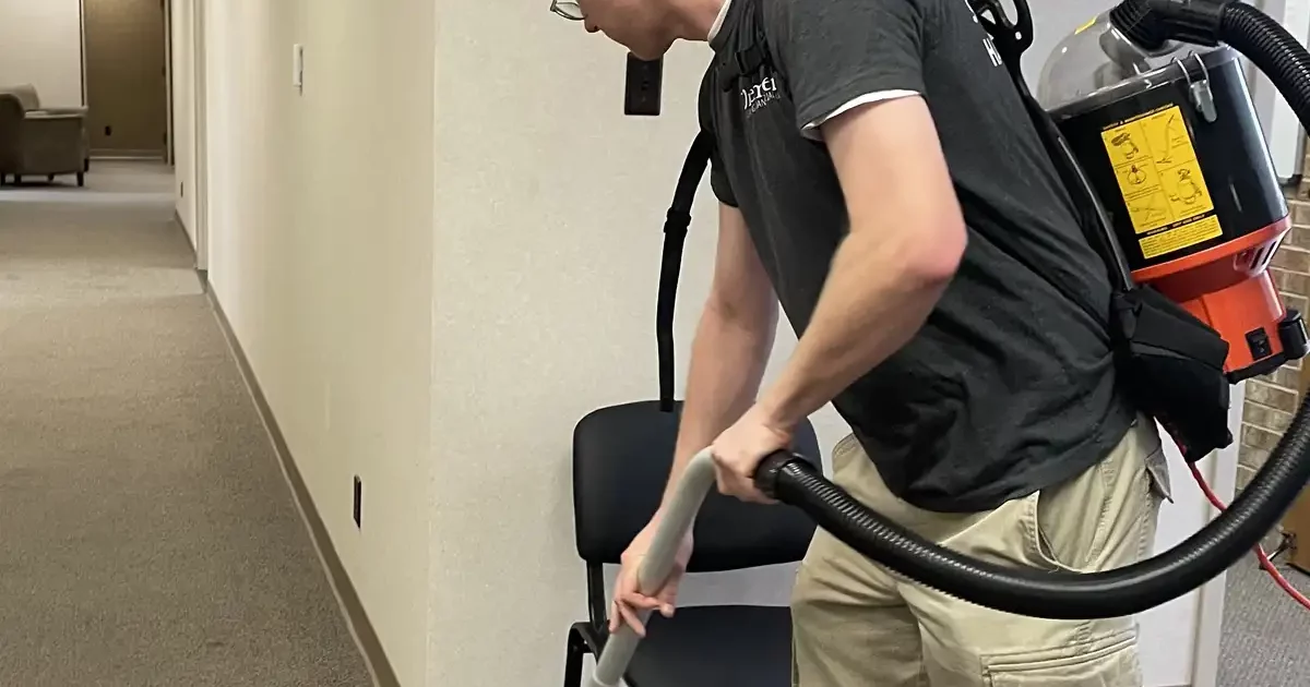 Premier Cleaning & Janitorial employee vacuuming office floor